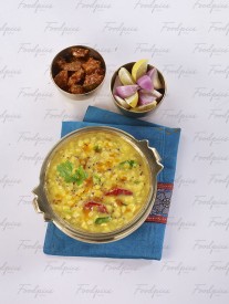 Dal Fry Yellow lentil soup in traditional brass bowl image preview