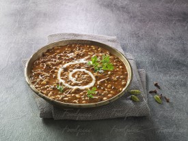 Dal Makhani Black lentil soup garnished wth cream image preview
