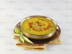 Dal Fry Yellow lentil curry in traditional vessel image preview