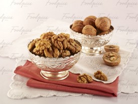 Walnuts Shelled and whole walnuts in silver bowls preview