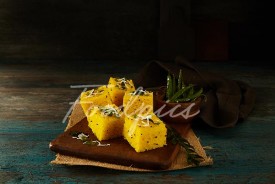 Dhokla Steamed lentil cakes on wooden platter image preview