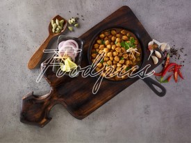 Chole Masala Spicy chick pea curry in a rustic pan preview