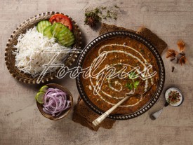 Dal Makhani Black lentil curry & accompaniments in traditional bowl image preview